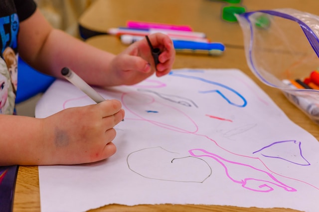 kids doodling on paper at a nursery
