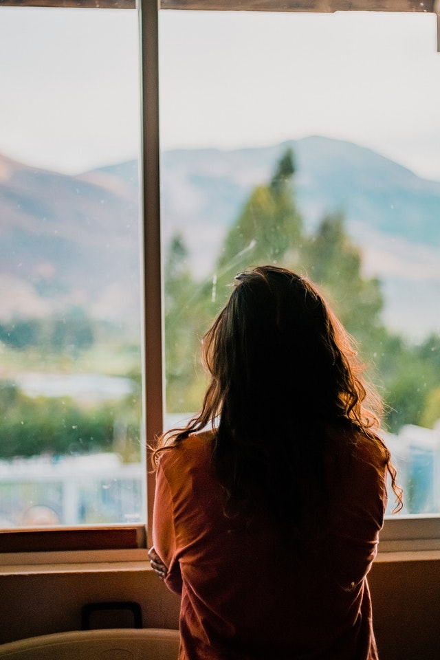 woman looking outside in thought
